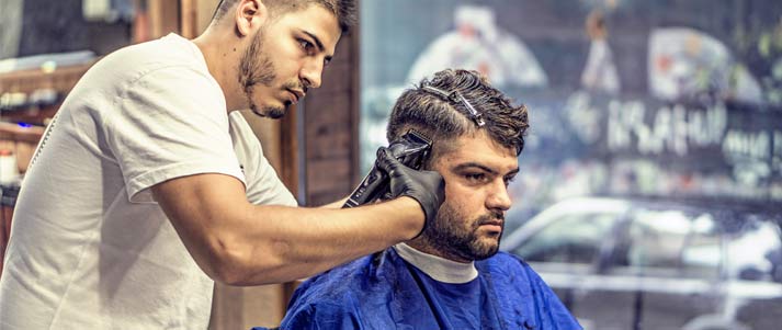 barber cutting hair with razor