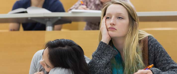 bored woman in lecture theatre