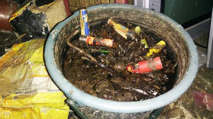 bucket filled with liquid and cigarettes