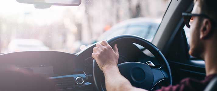 man with sunglasses driving car