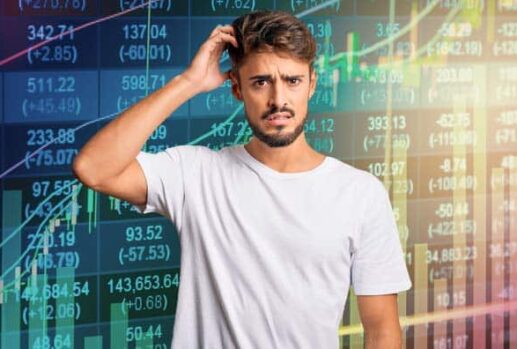 confused man in front stock market charts