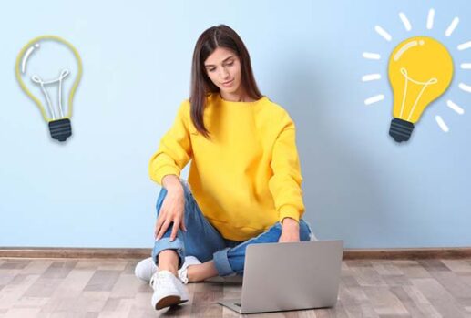 Woman at laptop with lightbulbs