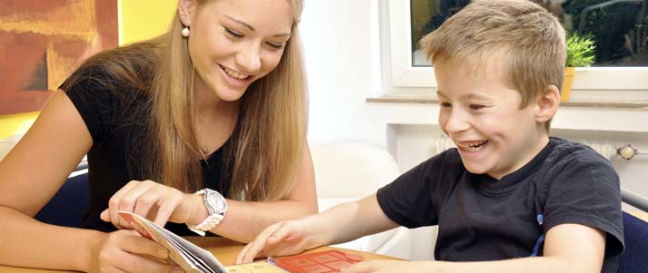 girl tutoring young boy