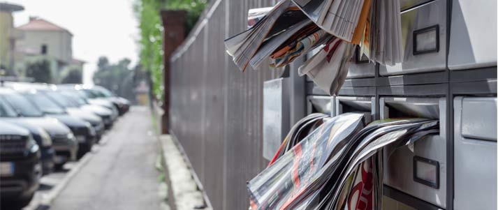 post boxes filled with junk