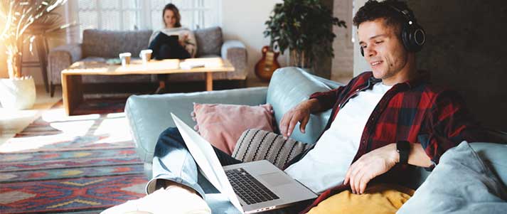 Man on laptop listening to music