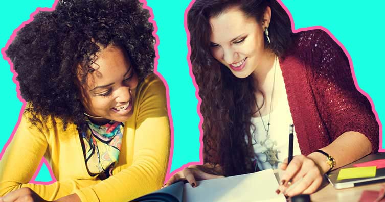 Two women looking at notes