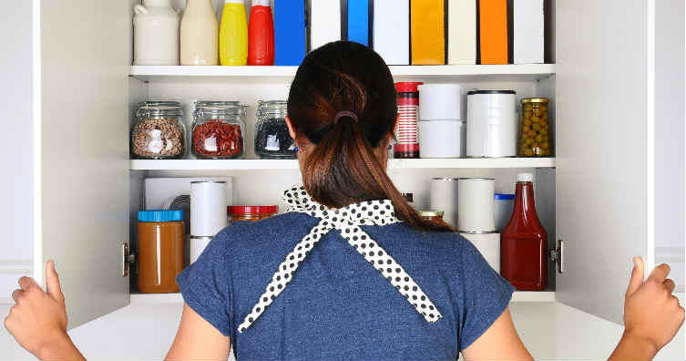 woman looking in kitchen cupboard