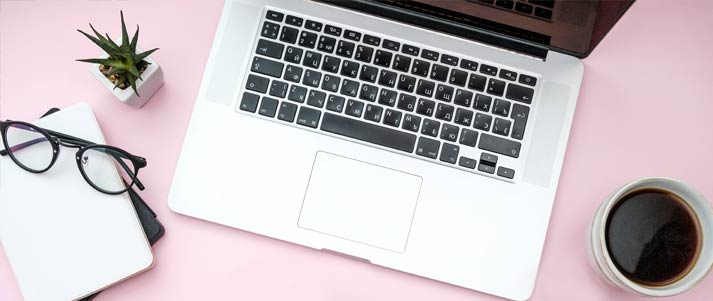 laptop with notebook, glasses and cup of coffee