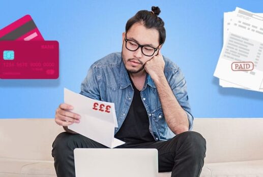 Man on sofa looking at paper with card and invoice