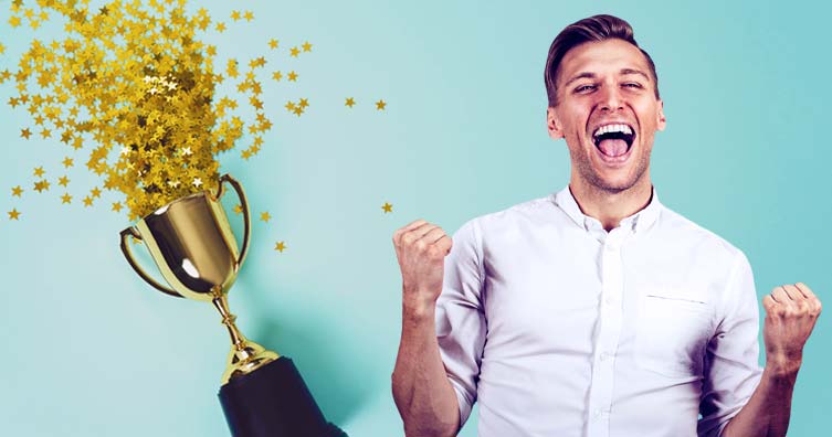 man celebrating and trophy with confetti