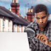 man using magnifying glass with terrace background