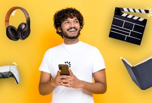 Man with phone, headphones, games controller, clapperboard and a book