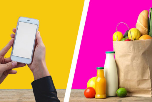 woman holding phone and bag of groceries