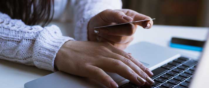 woman shopping online with debit card