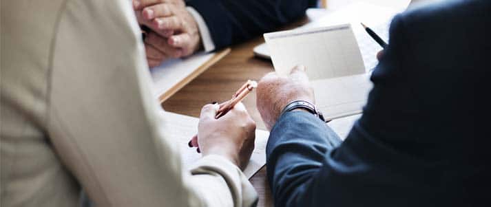 people signing documents