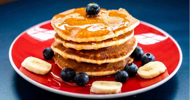 stack of pancakes with fruit toppings