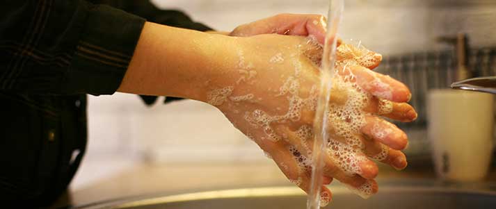 person washing hands with soap