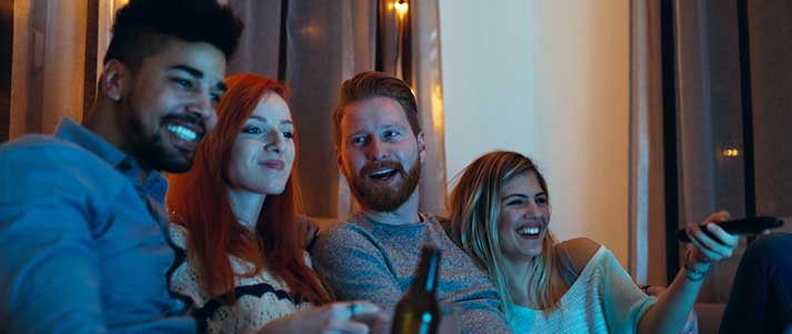 Four friends watching tv together