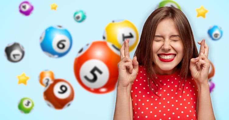 woman crossing fingers in front of lottery balls