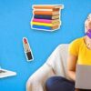 woman holding card with books, lipstick, laptop and a gift