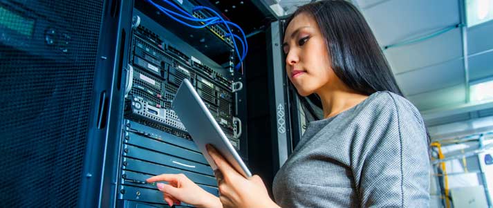 woman standing by computer servers