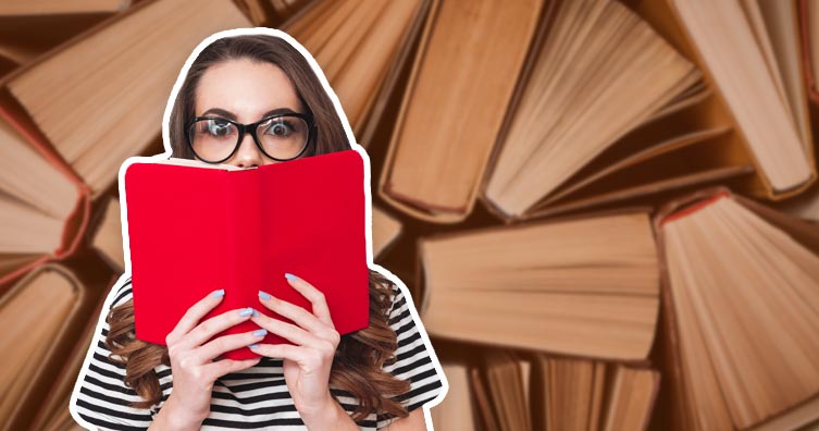 woman holding book in front of books