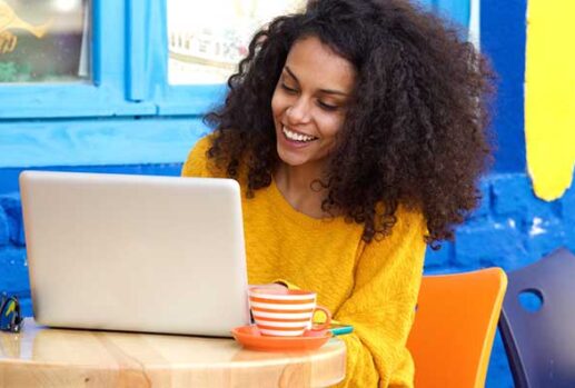 woman on laptop in colourful cafe